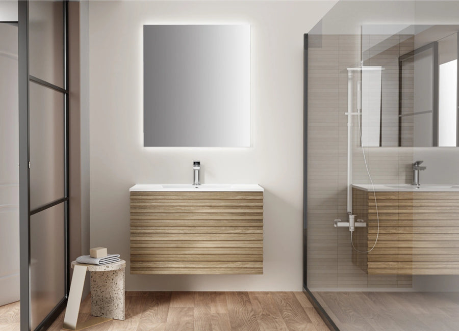 Floating wood vanity with a white countertop and illuminated mirror